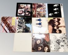 A collection of vinyl records, The Beatles' Revolver, Rubber Soul, The White Album, Please Me, Help,