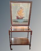 A 20th century oak two-tier tea trolley together with tapestry fire screen