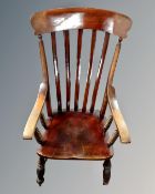 A 19th century stained beech rail backed kitchen armchair