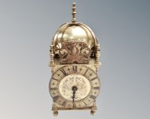 A reproduction brass lantern clock.
