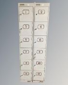 A pair of narrow metal six door lockers with eleven keys