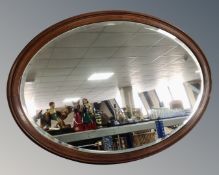 An Edwardian oval bevelled mirror.