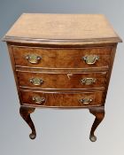 A 20th century walnut three drawer bow fronted bedside chest