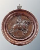 A bronze plaque depicting Charles I on horseback in oak frame.