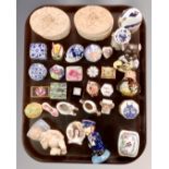 A tray of miniature pillboxes, a ceramic figure of a child, continental figures etc.