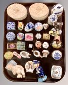 A tray of miniature pillboxes, a ceramic figure of a child, continental figures etc.