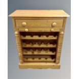 A contemporary pine wine rack fitted a drawer