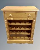 A contemporary pine wine rack fitted a drawer