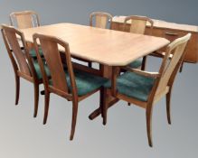 A mid century teak G-plan extending dining table and six chairs