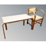 A 20th century beech bentwood armchair together with Esavian melamine topped table