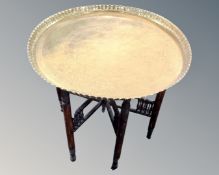 A folding Indian brass topped table