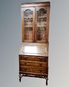 A 1930's leaded glass door oak bureau bookcase