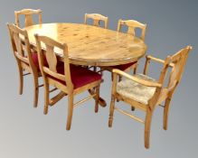 A Ducal pine circular pedestal extending dining table together with six chairs