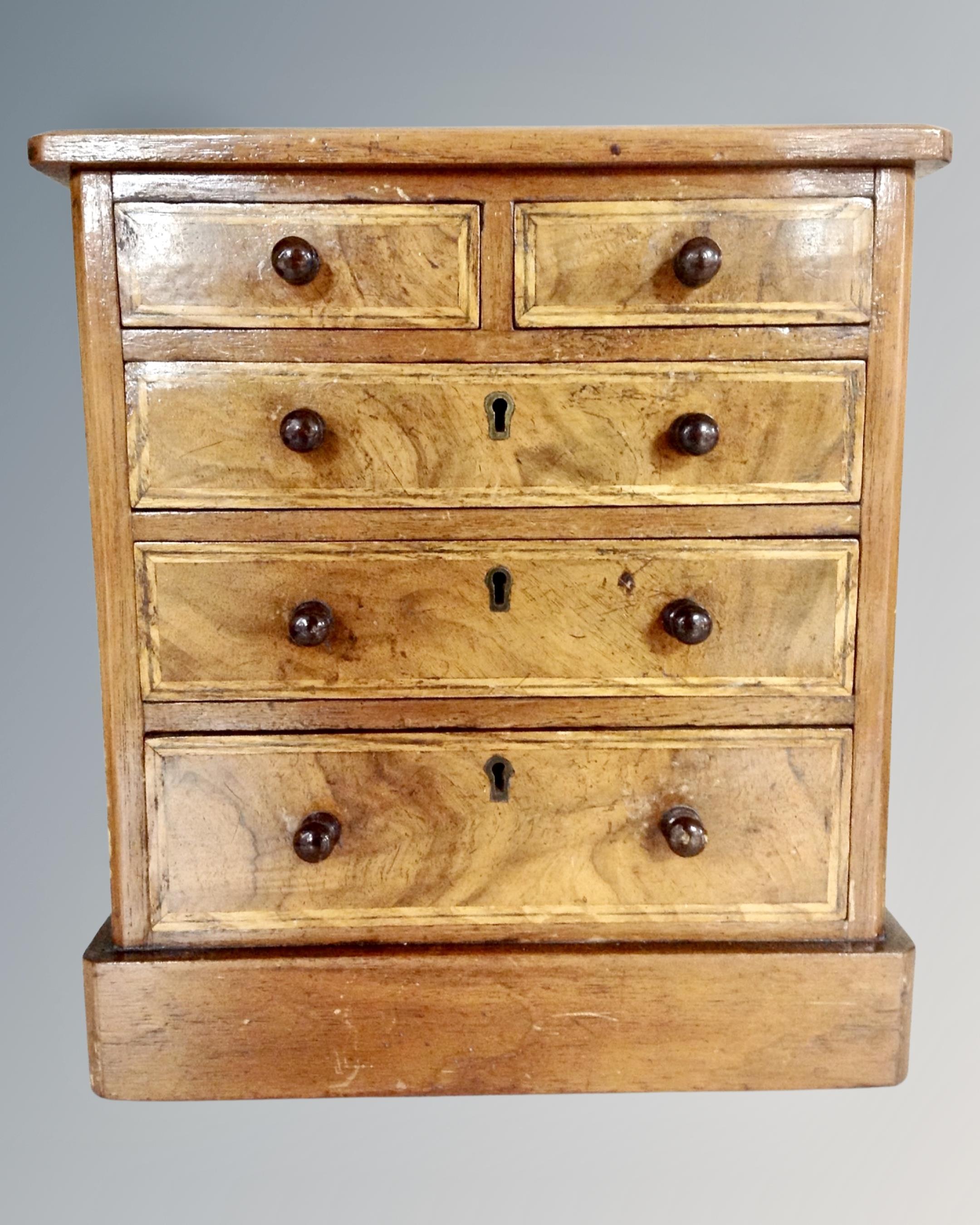 A 19th century inlaid mahogany apprentice chest.
