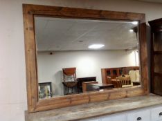 A large rustic pine bevelled overmantel mirror