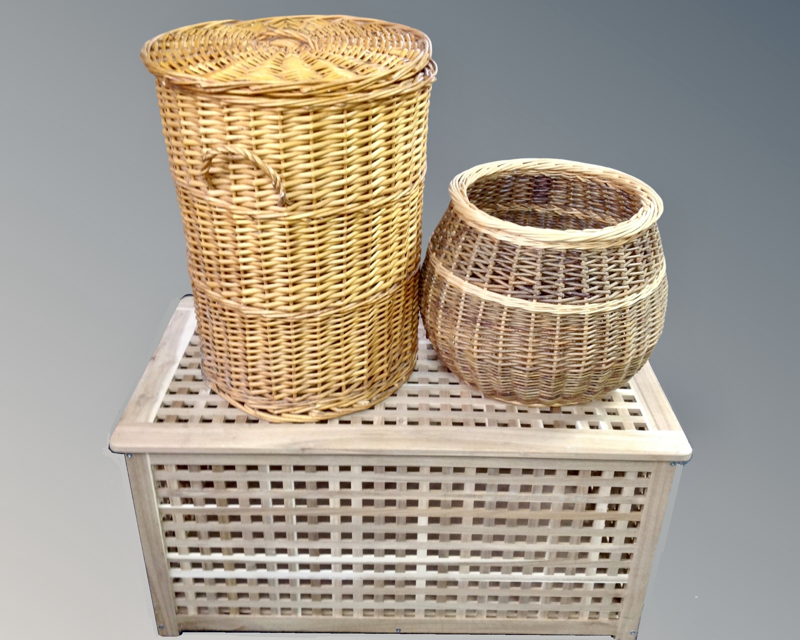 A teak linen box and two wicker baskets