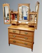 A 19th century satin wood four drawer dressing chest with triple mirror