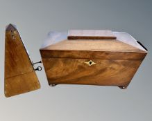 A Regency mahogany sarcophagus tea caddy, width 30cm, together with a metronome.