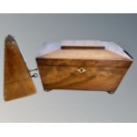 A Regency mahogany sarcophagus tea caddy, width 30cm, together with a metronome.