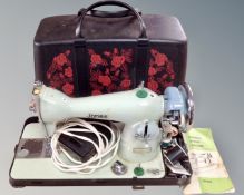 A vintage Jones electric sewing machine with pedal and case