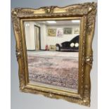 An antique style gilt framed mirror, 88cm by 100cm.