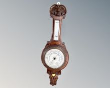 A carved oak banjo barometer.