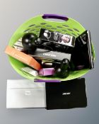 A basket containing three laptops, two table lamps, headphones etc.