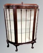 An Edwardian mahogany D-shaped display cabinet on claw and ball feet
