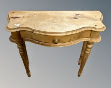 A pine serpentine fronted hall table fitted a drawer together with a yew wood D-shaped table