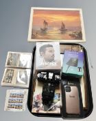 A Nikon camera together with Aeropex headphones, a Harrods phone case, picture of ship,