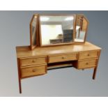 A G-Plan teak five drawer dressing table with triple mirror