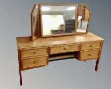 A G-Plan teak five drawer dressing table with triple mirror