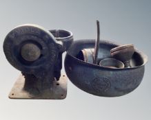 A cast metal cauldron cooking pot together with a vintage mincer.
