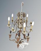 An antique continental brass eight branch chandelier together with a further metal and pottery five