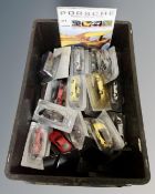 A box of Porsche Model Collection and other die cast vehicles together with four magazines