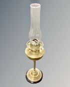 A 19th century Zimmerman brass oil lamp with chimney.
