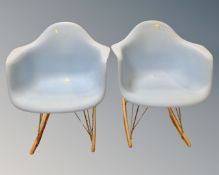 A pair of moulded plastic rocking chairs.