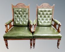 A pair of 19th century carved mahogany open armchairs upholstered in green button leather with a