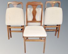 A set of four Scotts & Co. folding dining chairs.