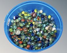 A tub of assorted glass marbles