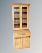 An Edwardian oak double door glazed bureau bookcase.