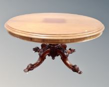 A Victorian mahogany oval pedestal dining table together with a set of four balloon back chairs.