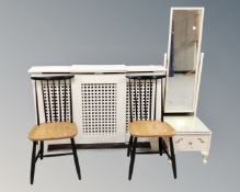 A pair of rail back kitchen chairs together with a cheval mirror and a painted radiator cabinet.