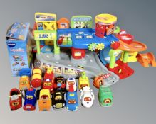 A Vtech toot toot drivers garage together with additional track set and twelve vehicles