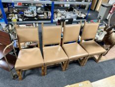 A set of four oak and studded leather dining chairs