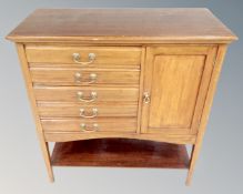 A late Victorian mahogany five drawer music cabinet fitted with cupboard.