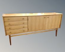 A mid-20th century A Younger Ltd teak double door sideboard fitted with four drawers,