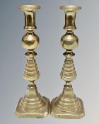 A pair of 19th century 'Queen of Diamonds' brass candlesticks
