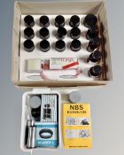 A tray containing a collection of microscope slide specimens, microscope lenses and adapter.