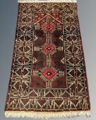 An Afghan rug of geometric design, 88cm by 148cm.